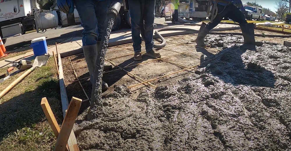 Pouring new concrete onto driveway in Orange County, CA.