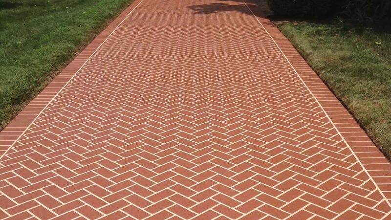 A new stamped concrete walkway with brick design.